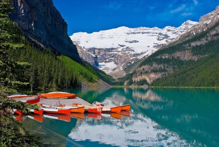 10385656 - on the placid turquise waters of lake louise, canoes waiting for canoeist, in banff national park